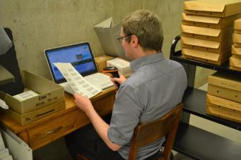 Archive Assistant Neil Adams barcoding boxes in the strongroom